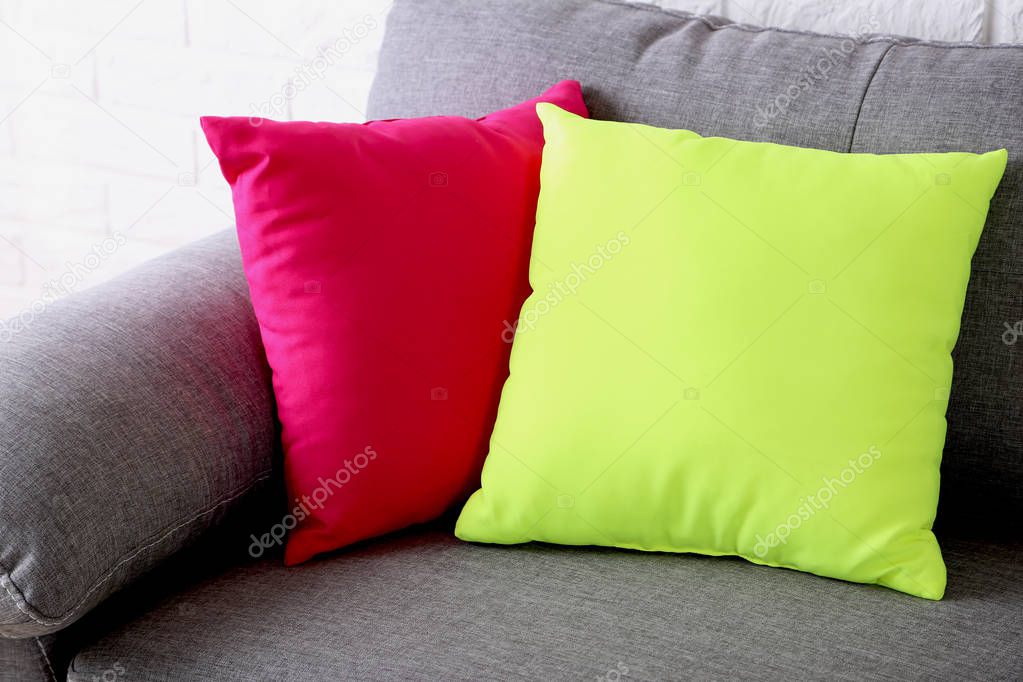 Colorful pillows on grey sofa