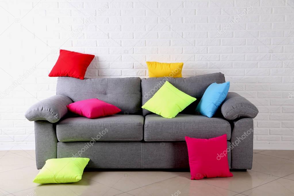Colorful pillows on grey sofa