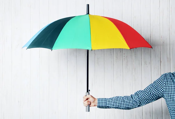 Colorful umbrella in male hand — Stock Photo, Image