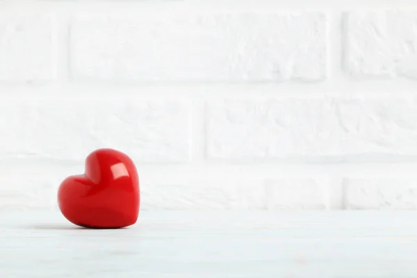 Red heart on brick wall