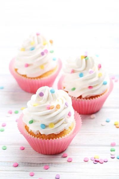 Tasty cupcakes on white table — Stock Photo, Image
