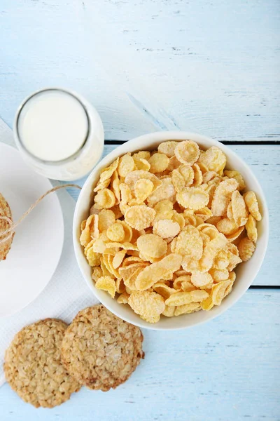 Cornflakes, bottle of milk and cookies — Stock Photo, Image