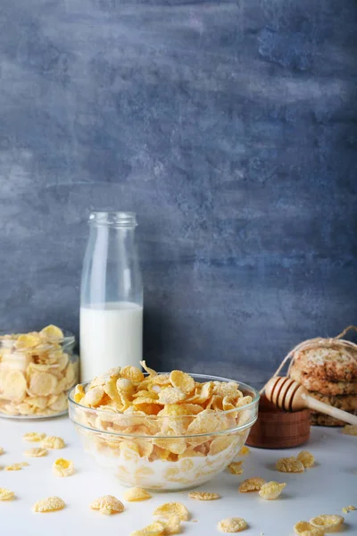 Copos de maíz con leche y un tazón de miel — Foto de Stock