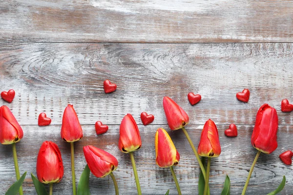 Bouquet of red tulips with hearts — Stock Photo, Image
