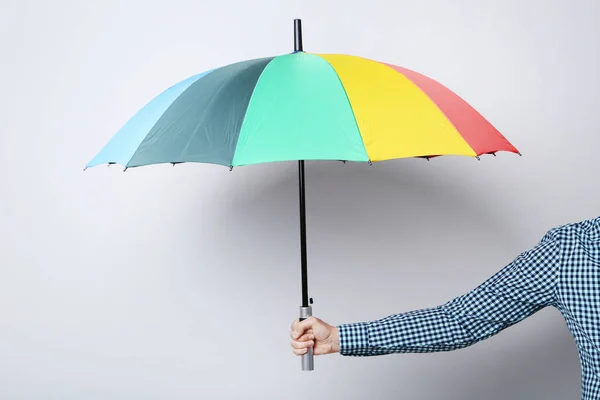 Male hand holding colorful umbrella — Stock Photo, Image