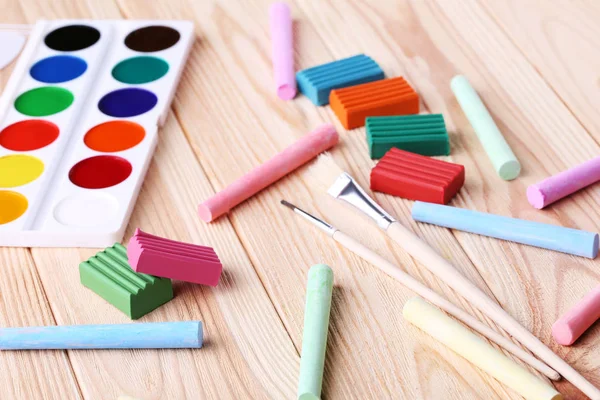 Aquarelles avec plasticine et crayons avec brosses sur la table — Photo