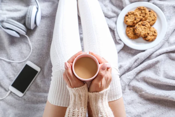 Mulher sentada com xícara de café na cama — Fotografia de Stock