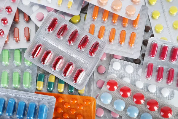Háttér, a különböző tabletták a csomagolásban — Stock Fotó