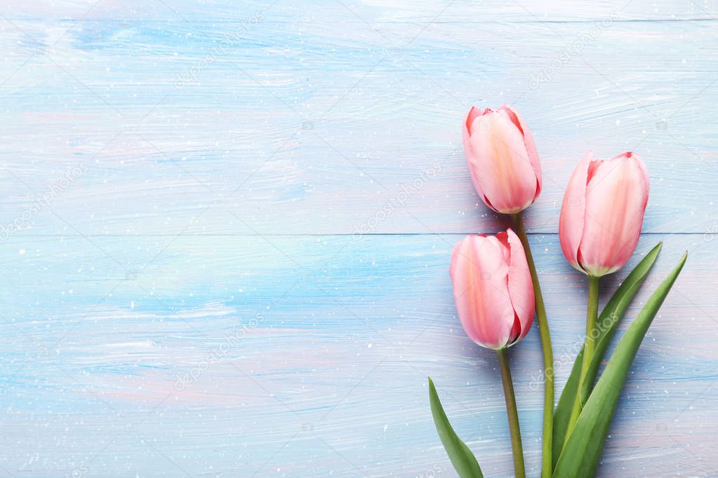 pink tulips on wooden tabletop