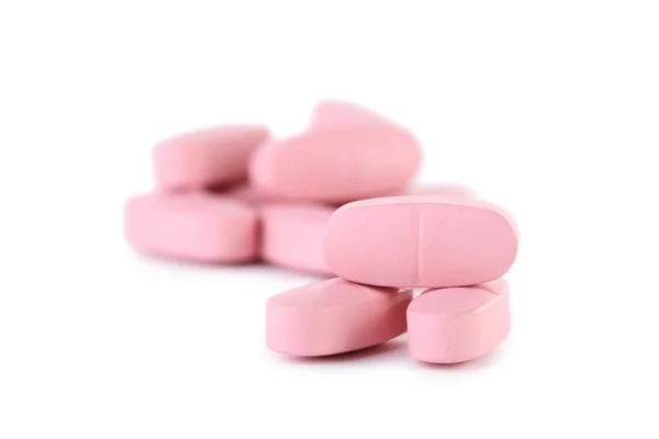 Pílulas rosa isoladas em um fundo branco — Fotografia de Stock