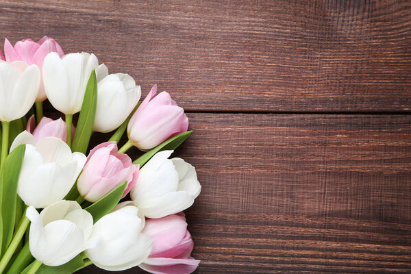 tulip flowers on wooden tabletop