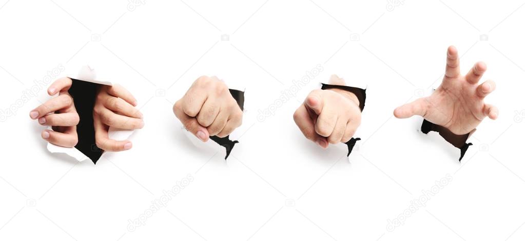 Male hands through paper