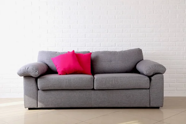 Colorful pillows on grey sofa — Stock Photo, Image