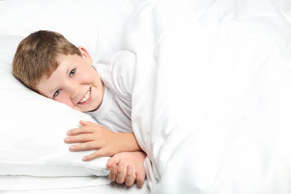 Young boy sleeping in white bed — Stock Photo, Image