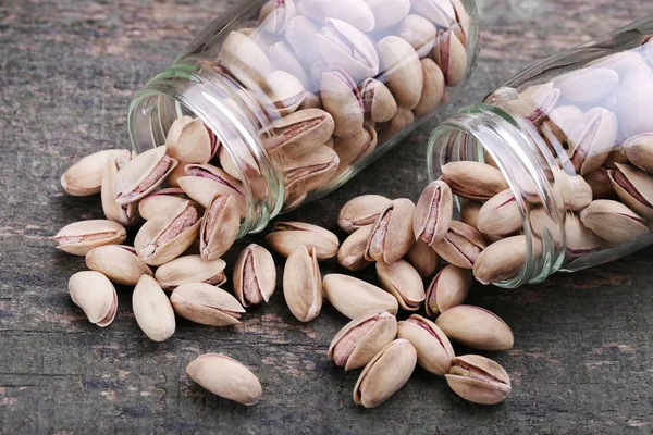 Pistachios in shells in bottles — Stock Photo, Image