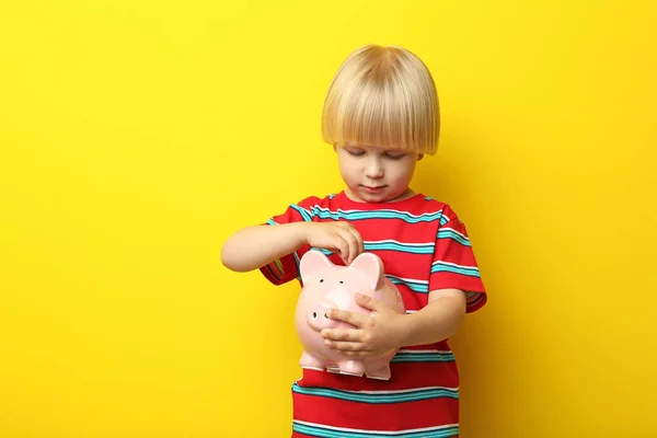 Little boy with piggy bank — Stock Photo, Image