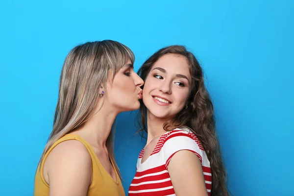 Portrait of two young woman on blue background — Stock Photo, Image