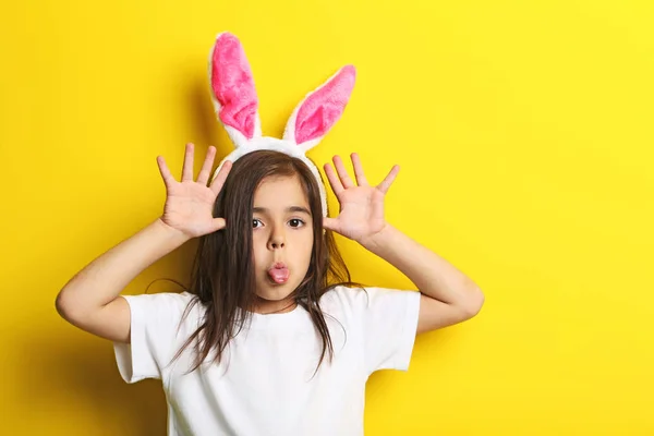 Hermosa niña con orejas de conejo sobre fondo amarillo —  Fotos de Stock