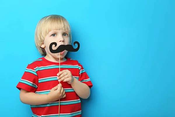 Portrait of little boy with paper mustache on blue background — Stock Photo, Image