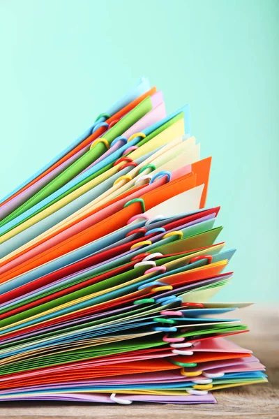 Stack of colored papers with paperclips — Stock Photo, Image