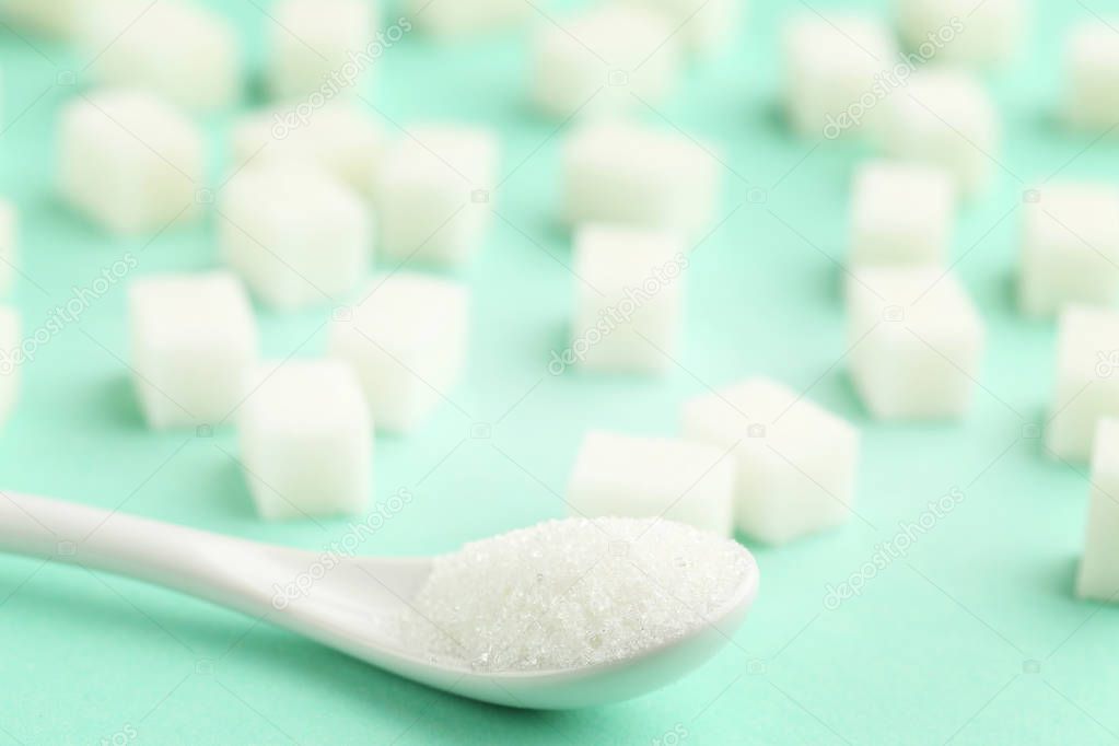 Sugar cubes with white spoon 