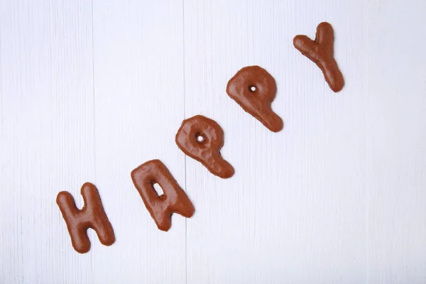 Palavra Feliz escrito por biscoitos de chocolate — Fotografia de Stock