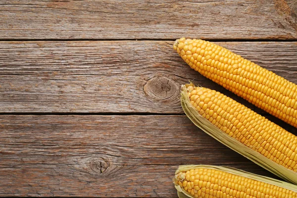 Sweet corns on grey wooden table — Stock Photo, Image