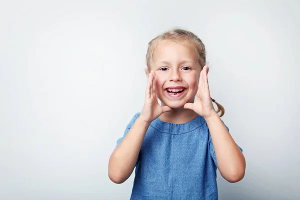 Portrait of little girl in blue dress on grey background — Stock Photo, Image