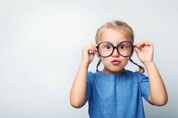 Portrait of little girl with glasses on grey background — Stock Photo, Image