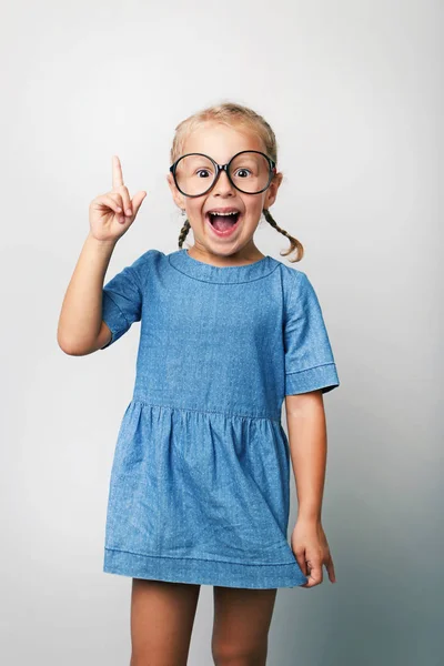 Portrait of little girl with glasses on grey background — Stock Photo, Image