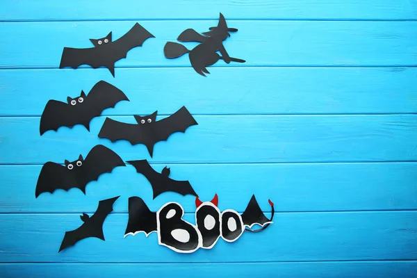 Halloween bats on blue wooden table — Stock Photo, Image