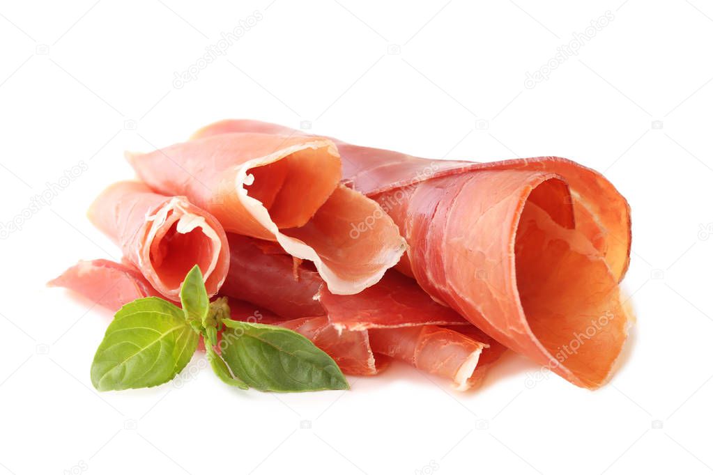 Slices of jamon with basil leaves