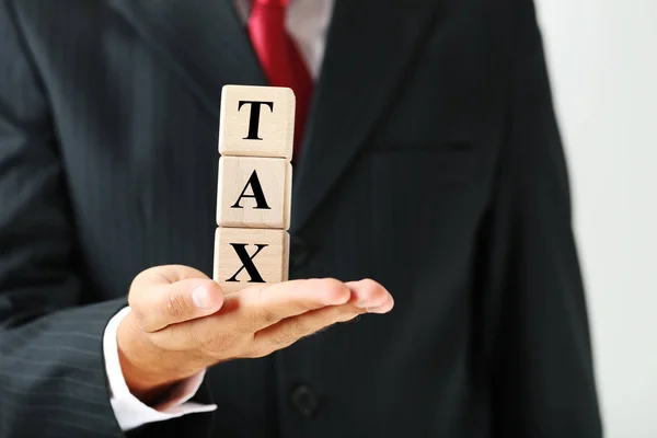 Businessman Holding Wooden Cubes Word Tax — Stock Photo, Image