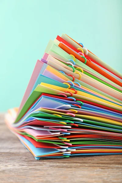 Stack of colored papers with paperclips — Stock Photo, Image
