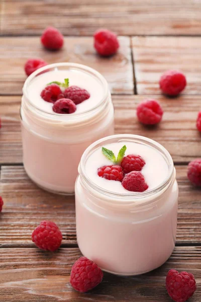 Raspberries yogurt in jars — Stock Photo, Image