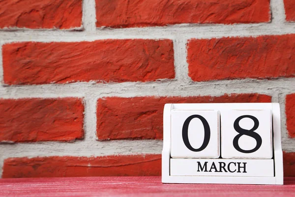 Cube calendar on a brick wall — Stock Photo, Image