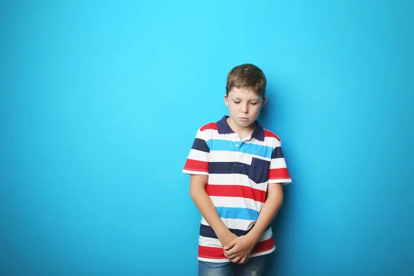 Porträtt av ledsen pojke på blå bakgrund — Stockfoto