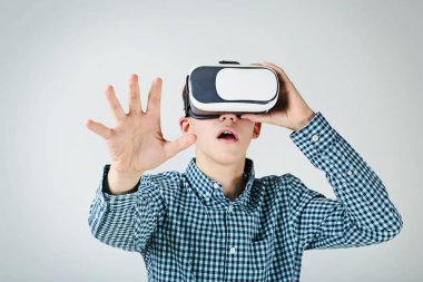 Sanal gerçeklik genç çocuk gri arka plan üzerinde koruyucu gözlük