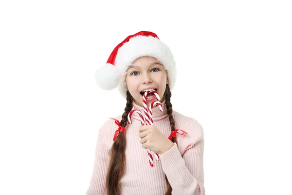 Jovem em santa chapéu com bengala de Natal doces em branco backg — Fotografia de Stock