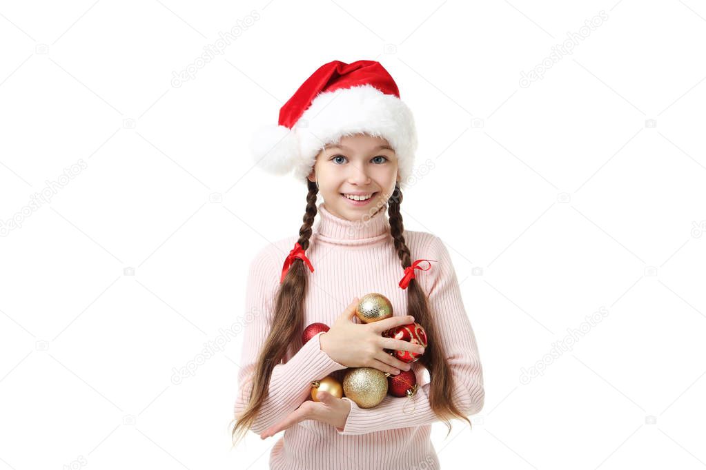 Young girl in santa hat with baubles on white background
