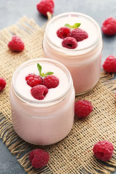 Raspberries yogurt in jars — Stock Photo, Image