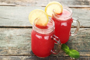 Ahşap masa üzerinde cam kavanozlara karpuz güler yüzlü