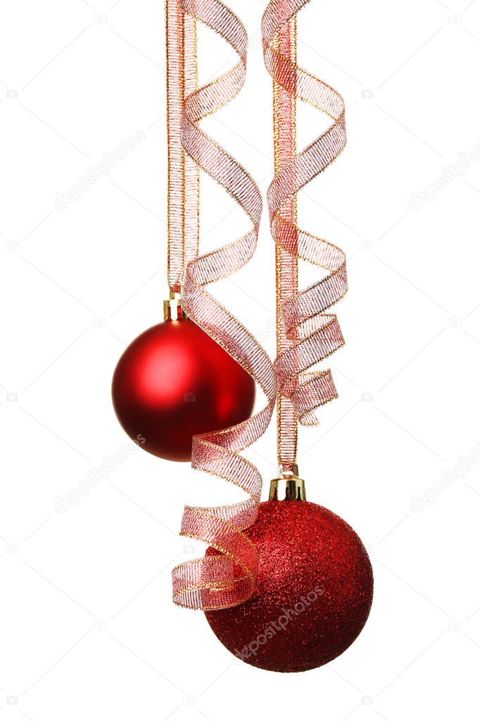 Christmas baubles hanging with ribbon on white background