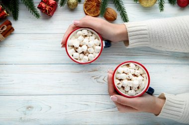 Kapuçino hatmi ile kupalar içinde tutan eller