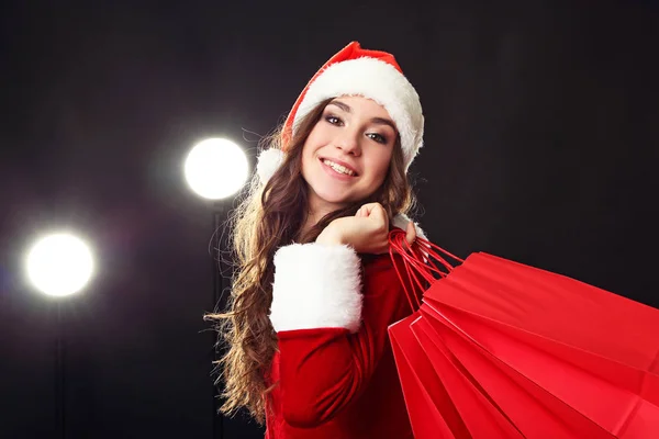 Young Woman Red Christmas Costume Holding Shopping Bags — Stock Photo, Image