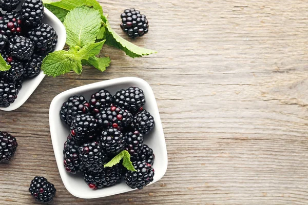 Ripe and sweet blackberries in bowls — Stock Photo, Image