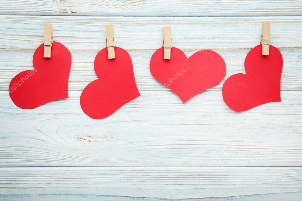 Red paper hearts hanging on rope