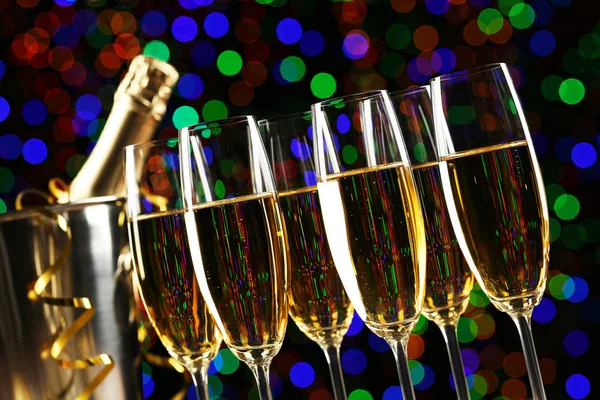 Champagne glasses on colourful lights — Stock Photo, Image