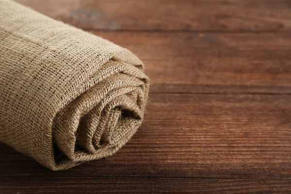 Rolled up sackcloth on  table — Stock Photo, Image