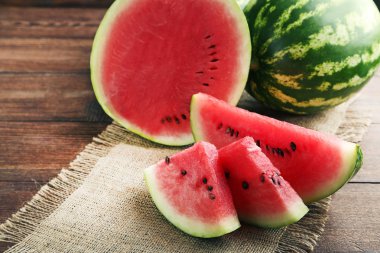 Slices of watermelons on table clipart